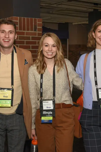 Five attendees wearing conference badges at the Illinois Governor's Conference. 