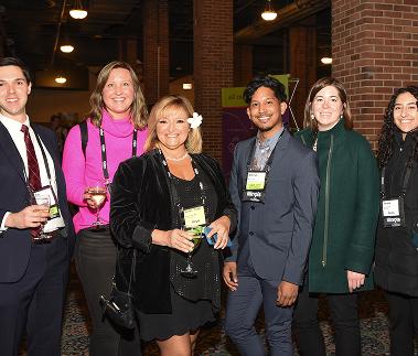 Tourism professionals posing together at a conference networking event. 