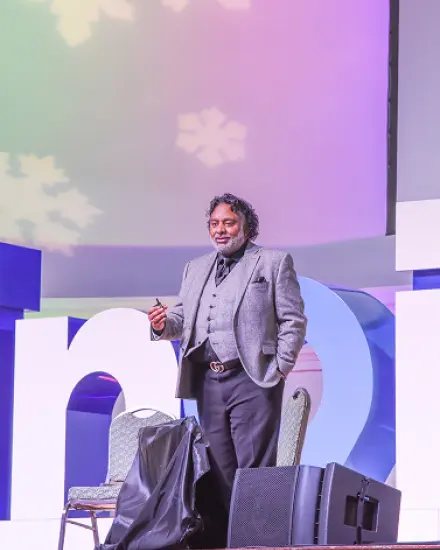 Speaker presenting on stage at the Illinois Governor's Conference. 