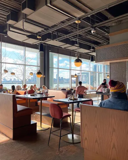 Restaurant with floor-to-ceiling windows overlooking Lake Michigan. 